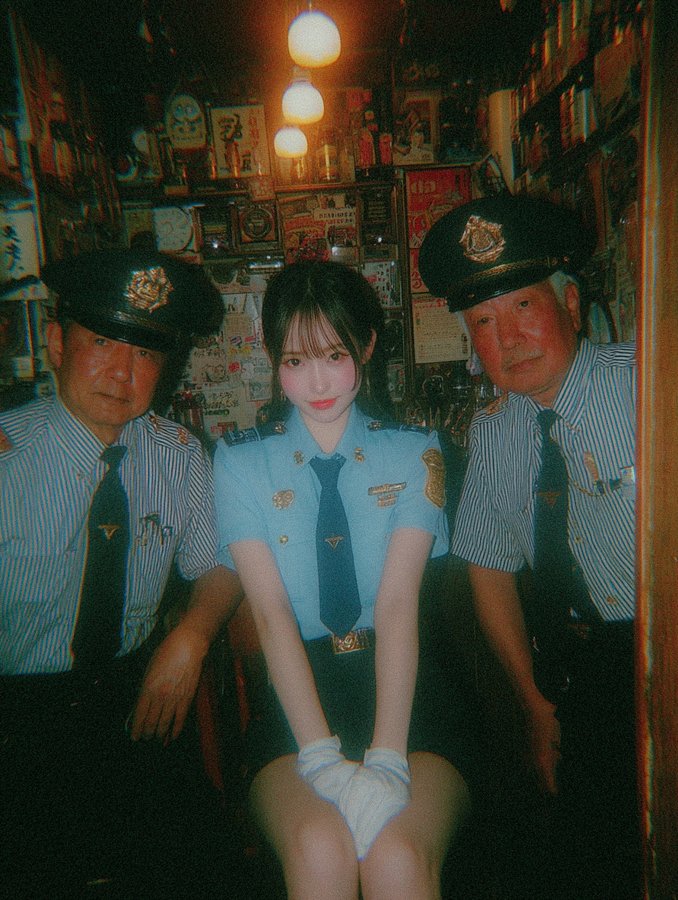 A beautiful Japanese woman in a light blue police uniform.