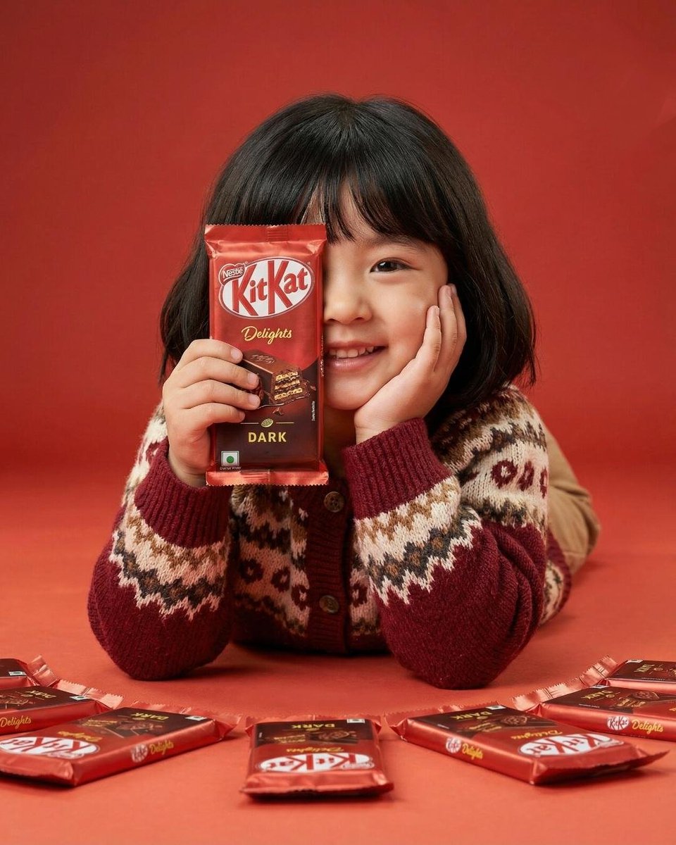 A cute young girl with short black hair and bangs smiling whi...